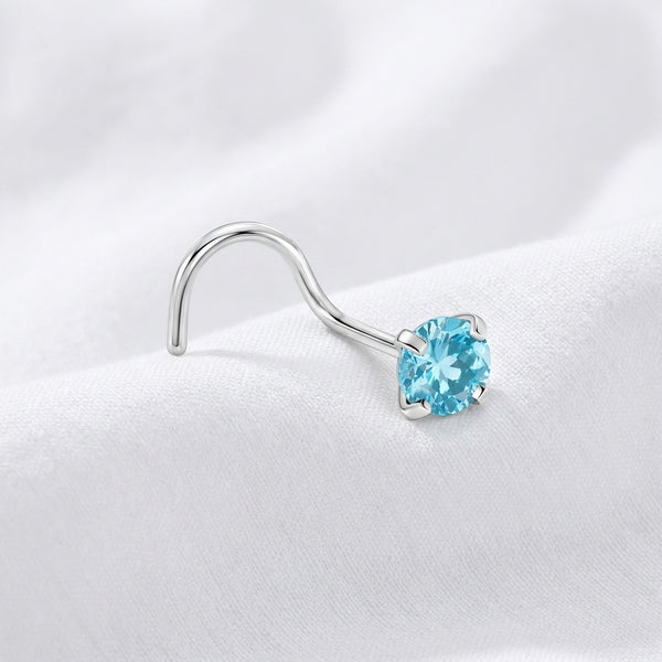 Vis nez argentee zircon solitaire bleu topaze — pose tissu blanc