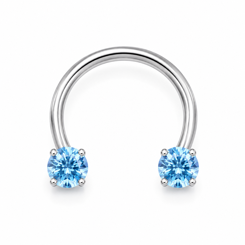 Fer a cheval septum argente 2 zircons bleus griffes - fond blanc