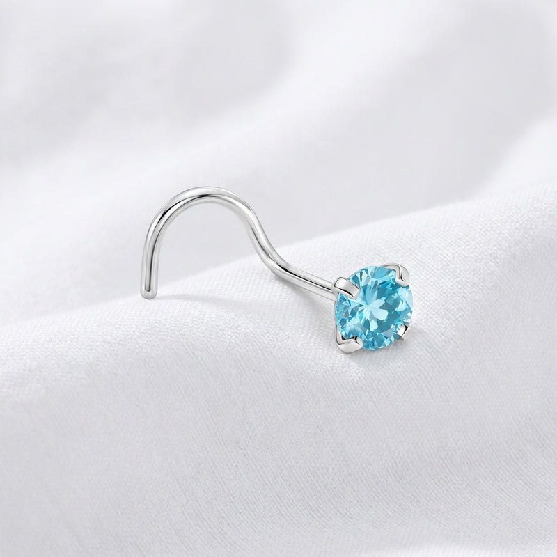 Vis nez argentee zircon solitaire bleu topaze — pose tissu blanc