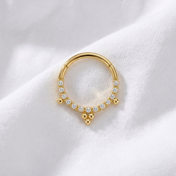Anneau clicker dore pave zircons 3 pendentifs boules — pose tissu blanc