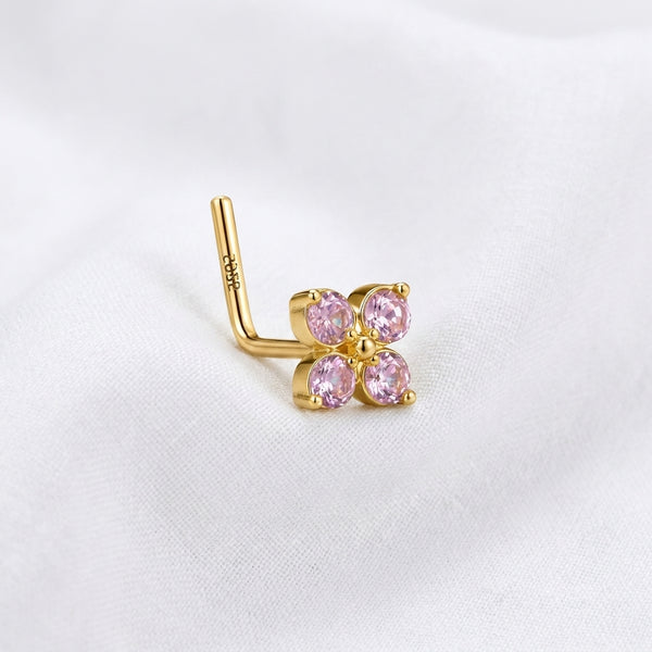 Clou en L dore fleur 4 petales zircons roses — pose tissu blanc