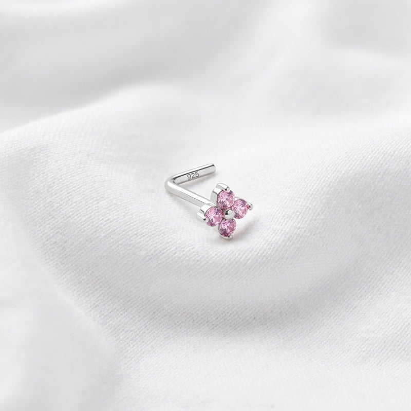 Clou en L argente fleur 4 petales zircons roses — pose tissu blanc